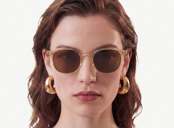 Front view of a pair of eyeglasses called the Idealist in Tan