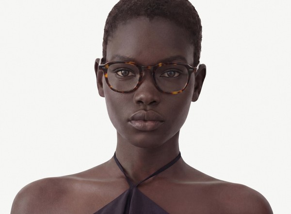 Front view of a pair of eyeglasses called the Doer in Tortoise