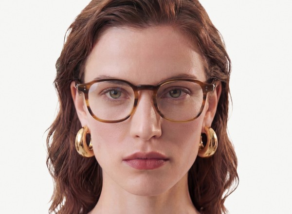 Front view of a pair of eyeglasses called the Idealist in Walnut