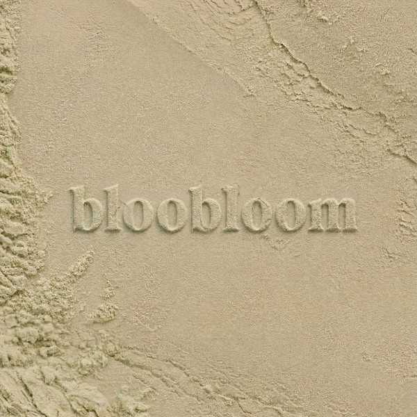 bloobloom logo pressed into textured sand
